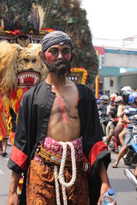 Full length of man standing on street in city