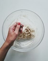 Directly above shot of woman kneading dough at table