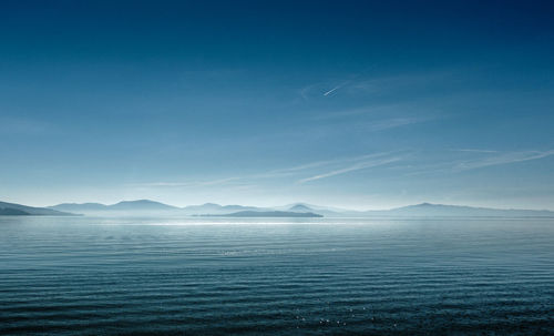 Scenic view of sea against blue sky