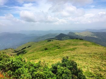 Scenic view of mountains against cloudy sky