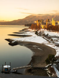 High angle view of bay against sky at sunset