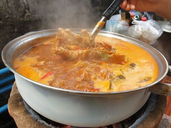 Cropped hand of person preparing food