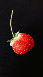 Close-up of strawberry over black background