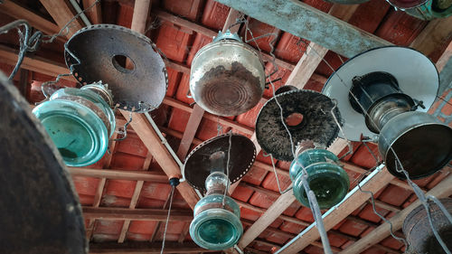 Low angle view of electric lamp hanging on ceiling