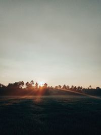 Scenic view of field against sky during sunset