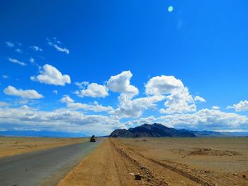 Scenic view of landscape against blue sky