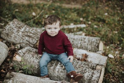 Portrait of boy sitting outdoors