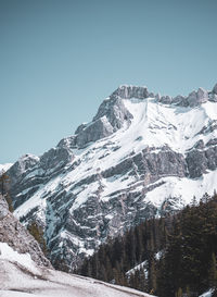 Scenic view of snowcapped mountains against clear blue sky