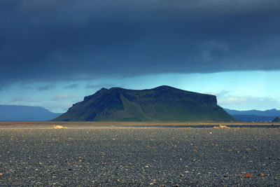 Scenic view of mountain against cloudy sky