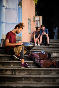 Young couple sitting on staircase