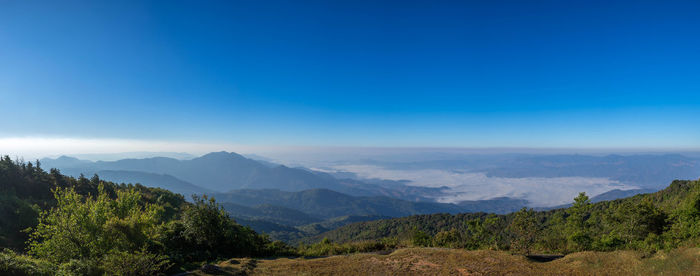 Scenic view of mountains against blue sky