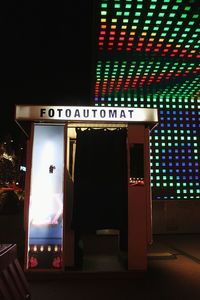 Illuminated information sign at night