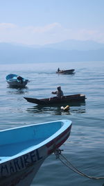 Boat moored on sea against sky