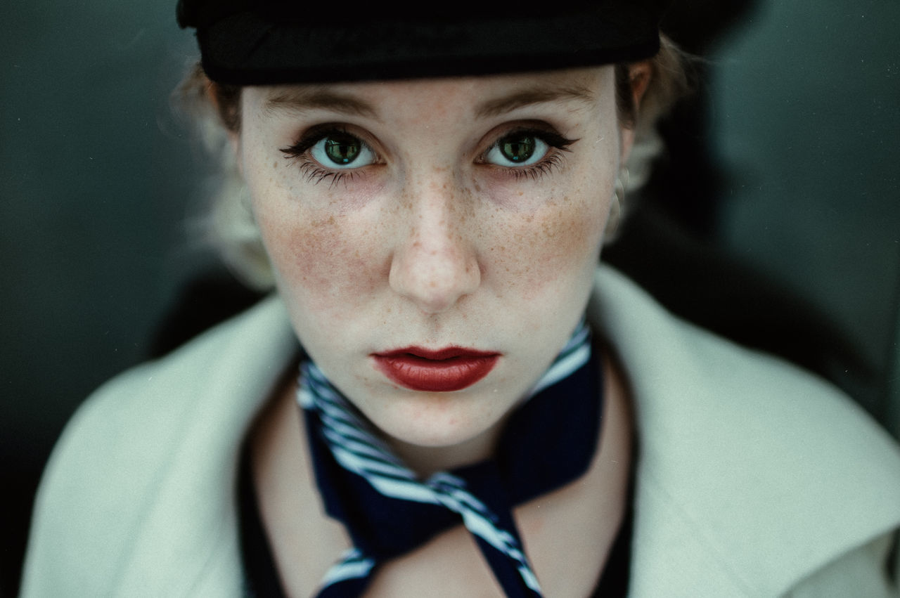 looking at camera, portrait, one person, real people, front view, young adult, headshot, bow tie, close-up, indoors, young women, day