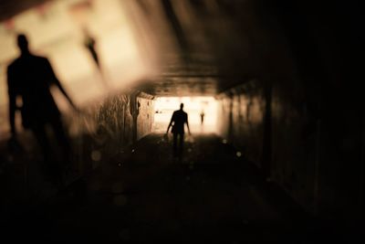 Silhouette man standing in tunnel