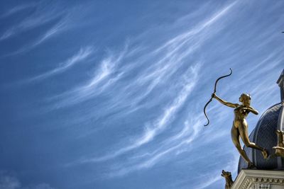 Low angle view of statue against blue sky