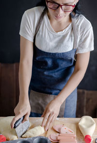 Midsection of young woman standing on table