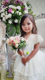 Portrait of young woman with bouquet