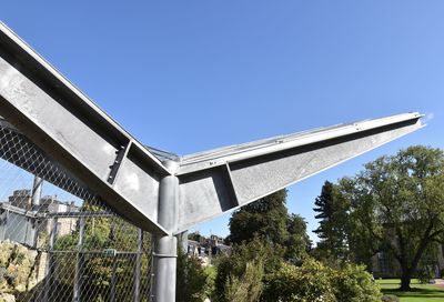 Low angle view of modern building against blue sky