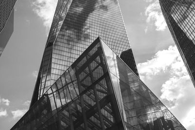 Low angle view of modern building against cloudy sky