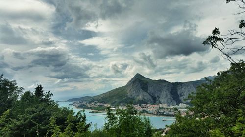 Scenic view of mountains against cloudy sky