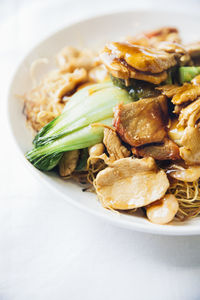 High angle view of food served in plate against white background