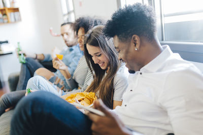 Happy friends sitting on the sofa