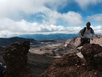 Rear view of man standing on mountain