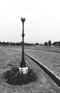 Street light on field against clear sky