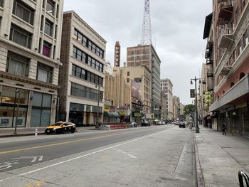 City street and buildings against sky