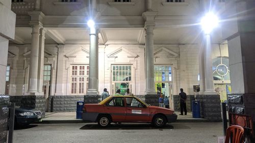 Cars on illuminated street in city