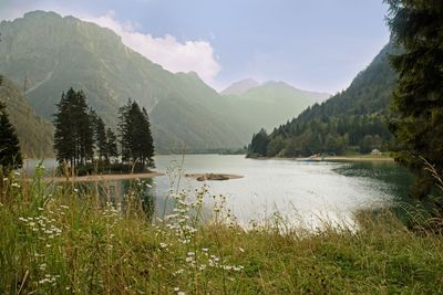 Scenic view of lake and mountains against sky