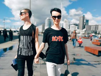 Full length of young man wearing sunglasses standing in city