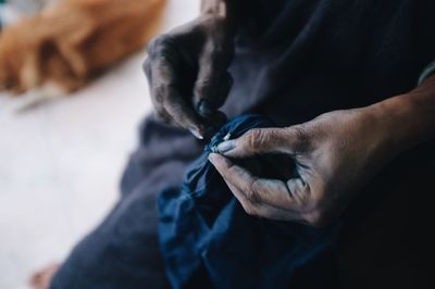 Midsection of person holding sewing fabric