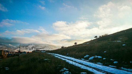 Scenic view of landscape against cloudy sky