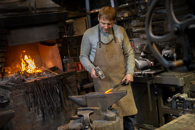 Blacksmith working in workshop