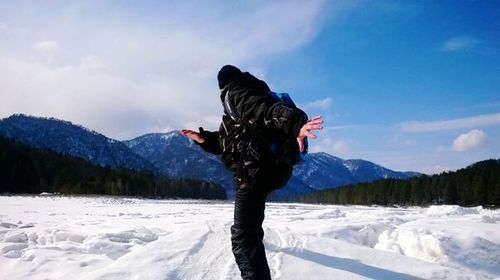 Person with arms outstretched in snow
