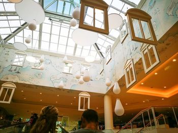 Low angle view of people hanging on ceiling