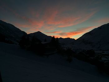 Scenic view of snowcapped mountains against sky during sunset