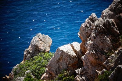 High angle view of rocks by sea