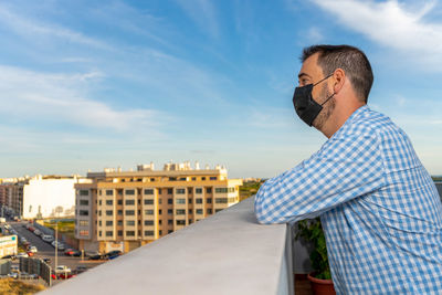 Midsection of man standing on city against sky