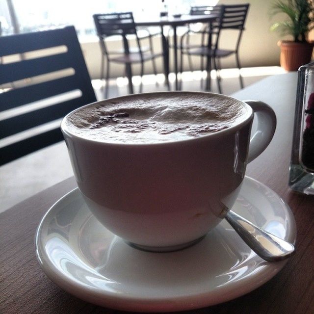 drink, food and drink, refreshment, coffee cup, table, coffee - drink, saucer, indoors, freshness, coffee, frothy drink, still life, close-up, cup, spoon, focus on foreground, beverage, cappuccino, cafe, drinking glass