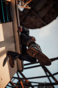 Low angle view of man on rusty metal