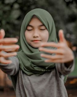 Portrait of teenage girl holding camera