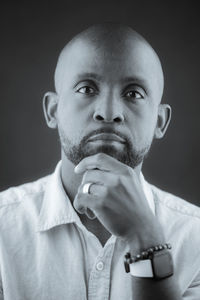 Portrait of mature man against black background