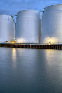 Big oil storage tanks at dusk seen in berlin