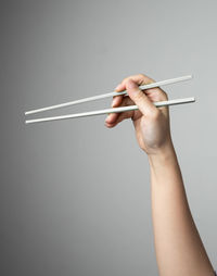 Close-up of hand holding hands over black background