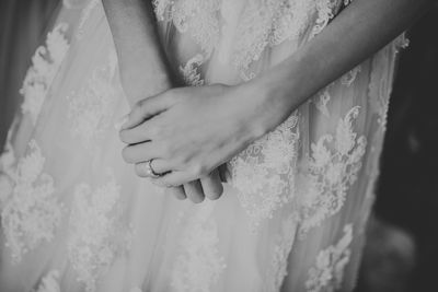 Midsection of bride wearing wedding dress during ceremony