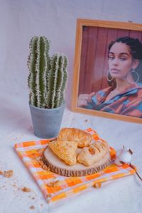 Woman holding ice cream in plate on table