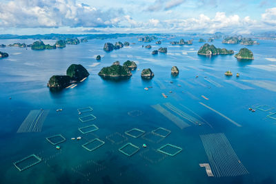 Aerial view of rock formations in sea against sky